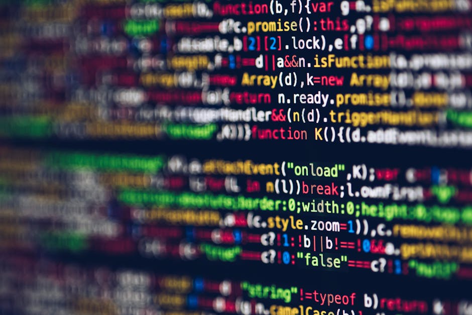 A close-up image of a computer screen displaying colorful lines of programming code, including various keywords, variables, and functions in shades of red, green, blue, yellow, and white on a dark bac